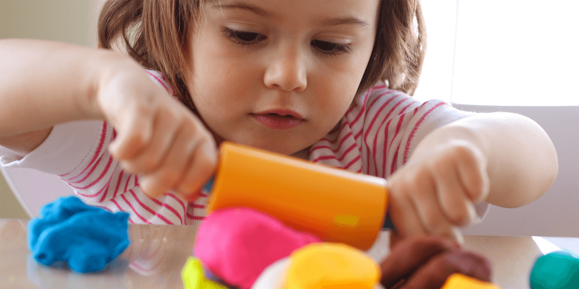 girl playing with playdough